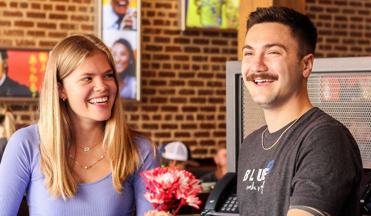 Smiling man and woman enjoying a moment of laughter.