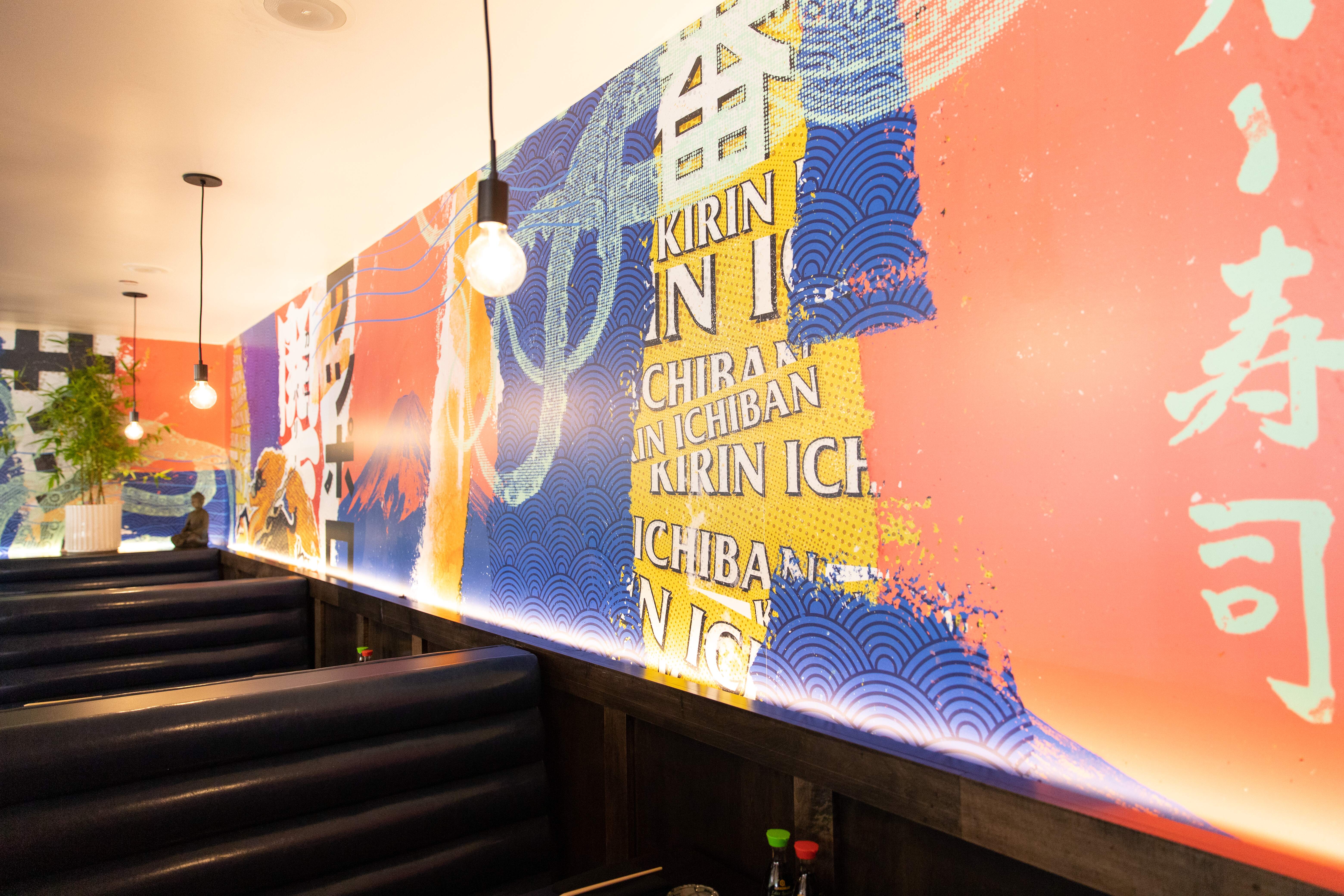 A colorful wall mural inside of Blue Sushi Sake Grill.