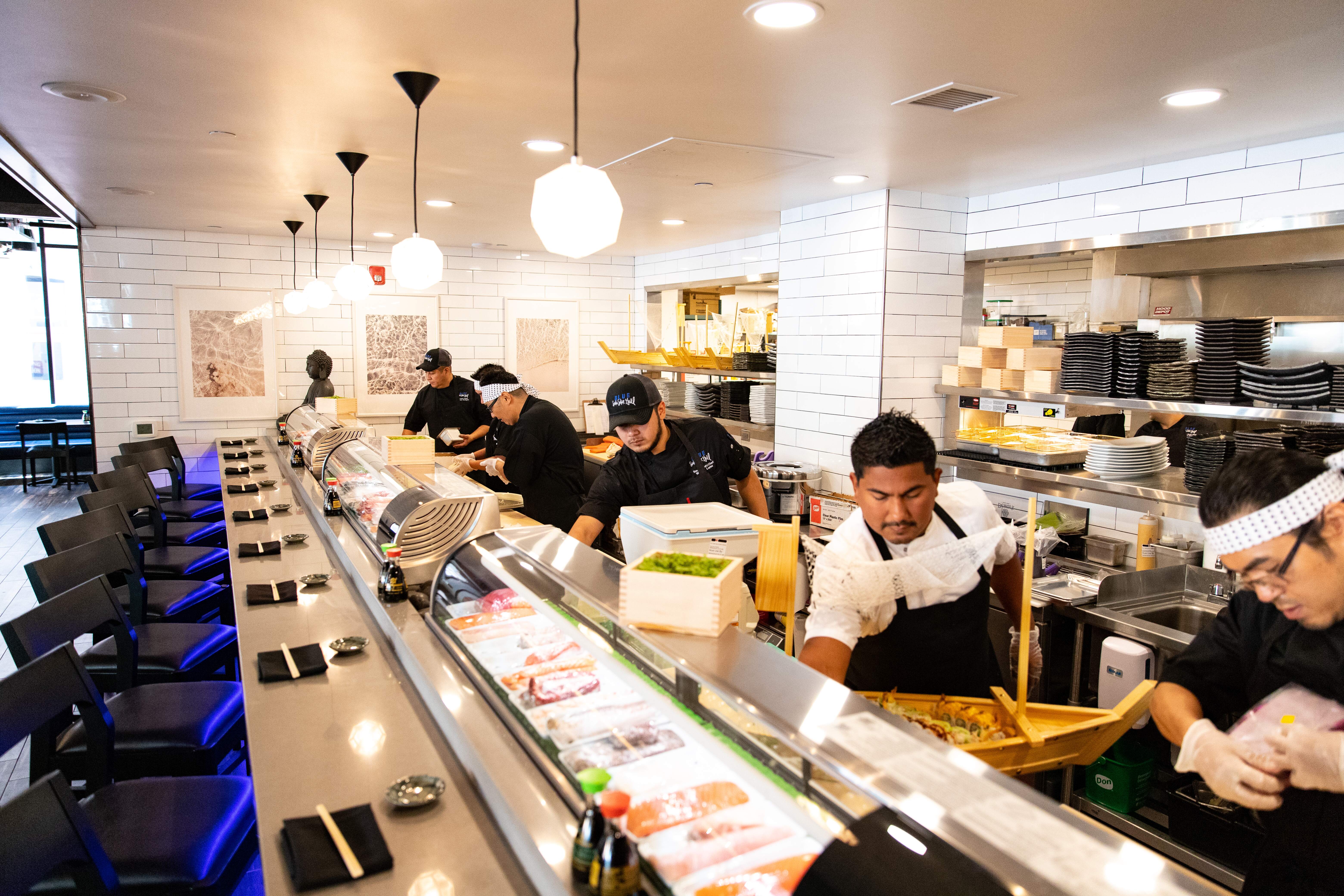Chefs cooking inside of Blue Sushi Sake Grill.