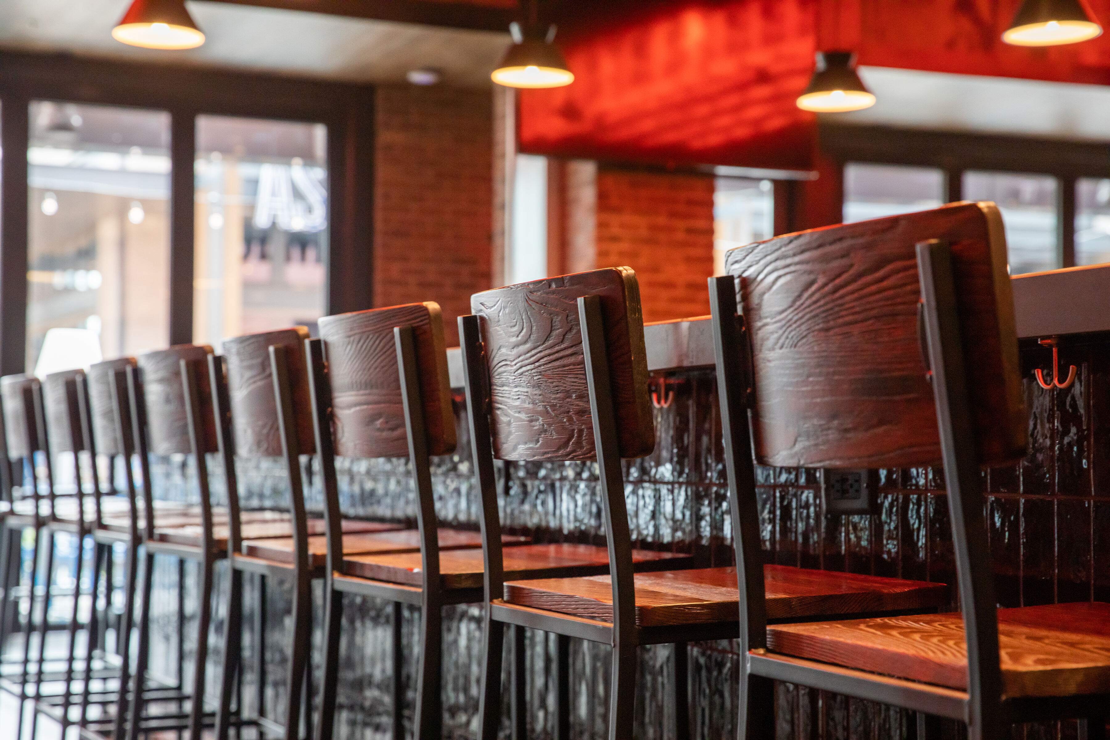 A line up of chairs at the bar. 