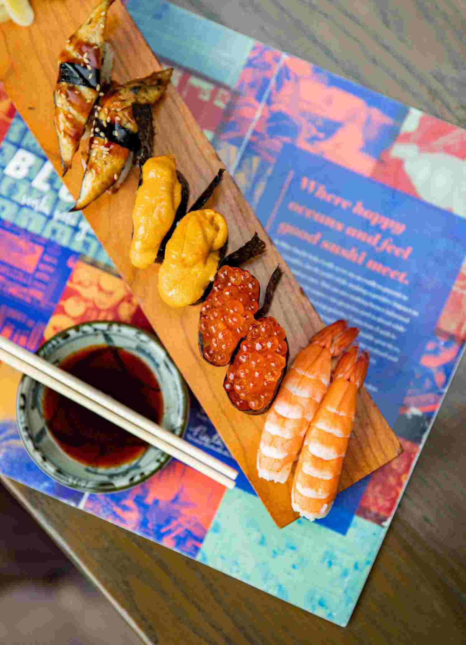 A Blue Sushi Sake Grill nigiri platter with a menu.
