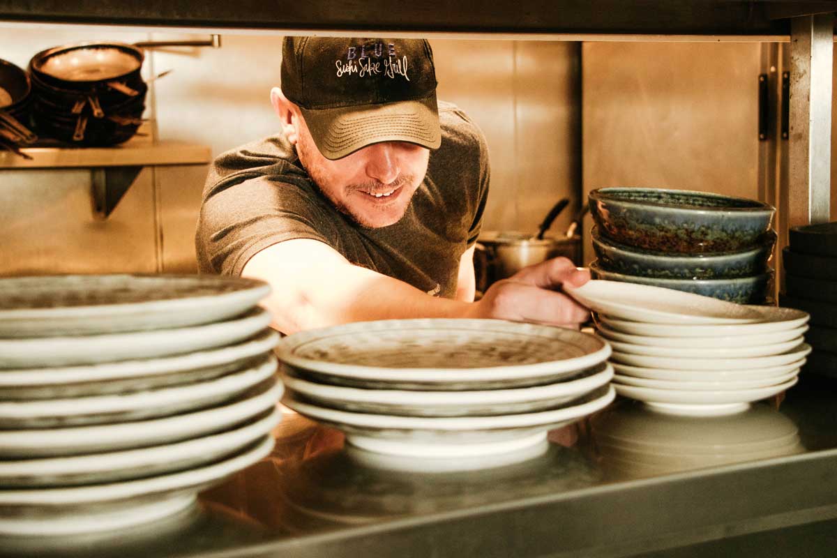 An employee at Blue Sushi Sake Grill working at the service station. 